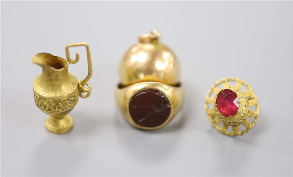 An 18ct and hardstone? set signet ring(a.f.), gross 6.4 grams, a yellow metal spherical hinged locket?, gross 3.9 grams & 2 charms.